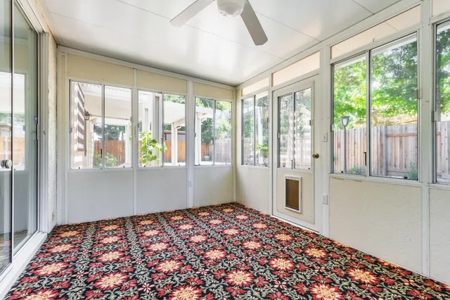 a backyard of a house with table and chairs