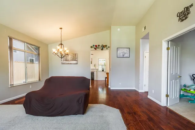 a living room with furniture chandelier and a window