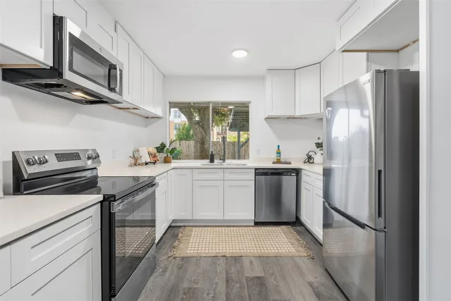 a kitchen with a refrigerator stove and sink