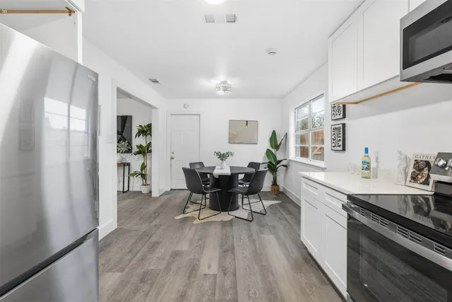 a kitchen with sink cabinets and stainless steel appliances