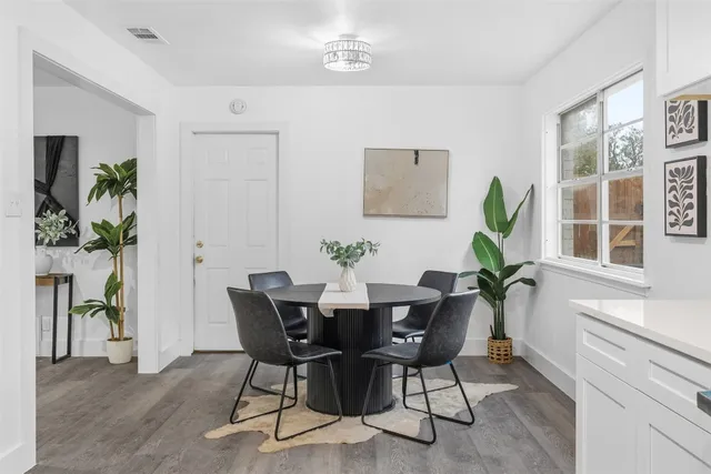 a view of a dining room with furniture window and wooden floor