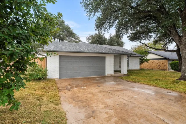 a front view of house with yard and trees