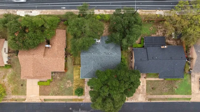an aerial view of residential houses with outdoor space