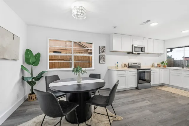a kitchen with a table and chairs in it