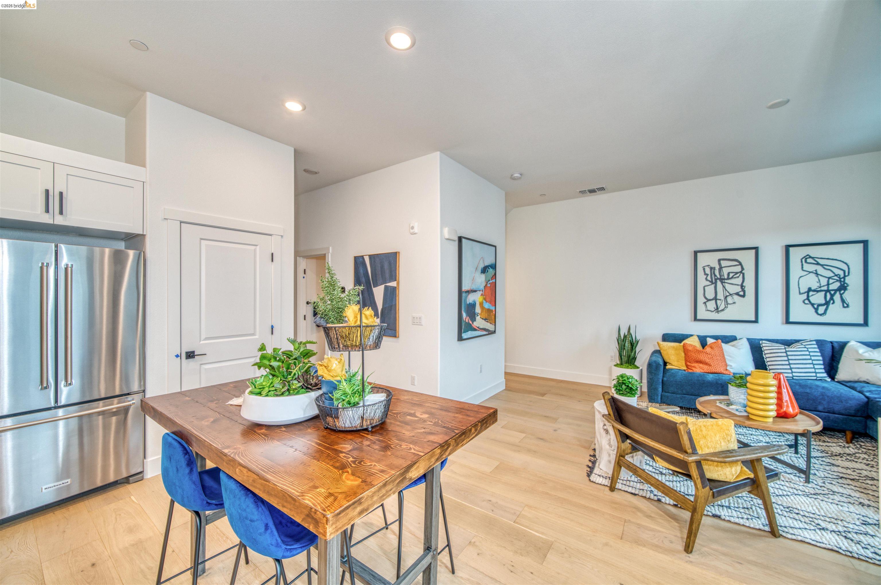 a living room with dining table furniture and a potted plant