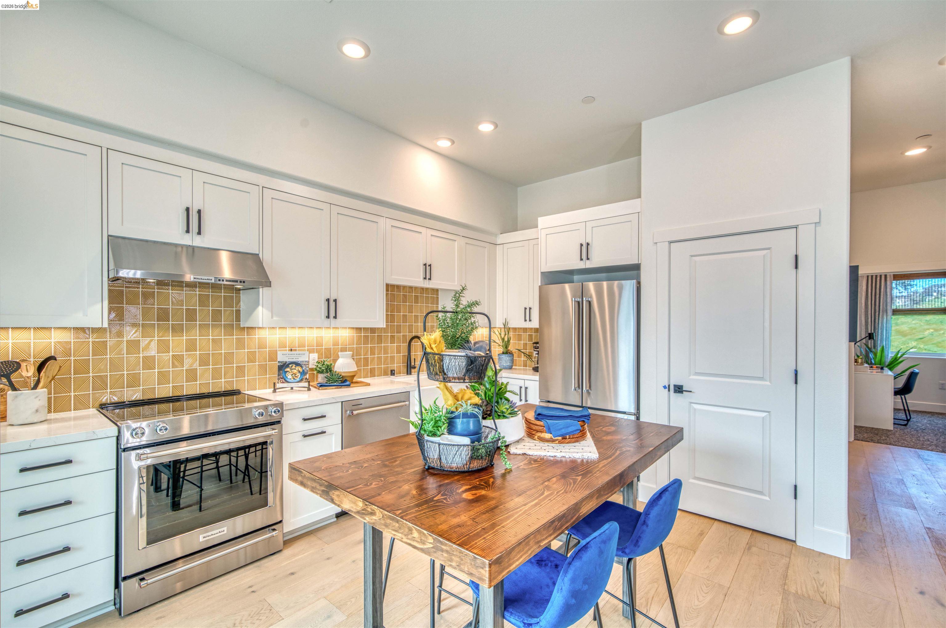 28951 Parkridge Loop, Unit 87 Hayward, CA 94544 - Photo 5 of 23 a kitchen with a stove a sink dishwasher a refrigerator and a stove with wooden floor