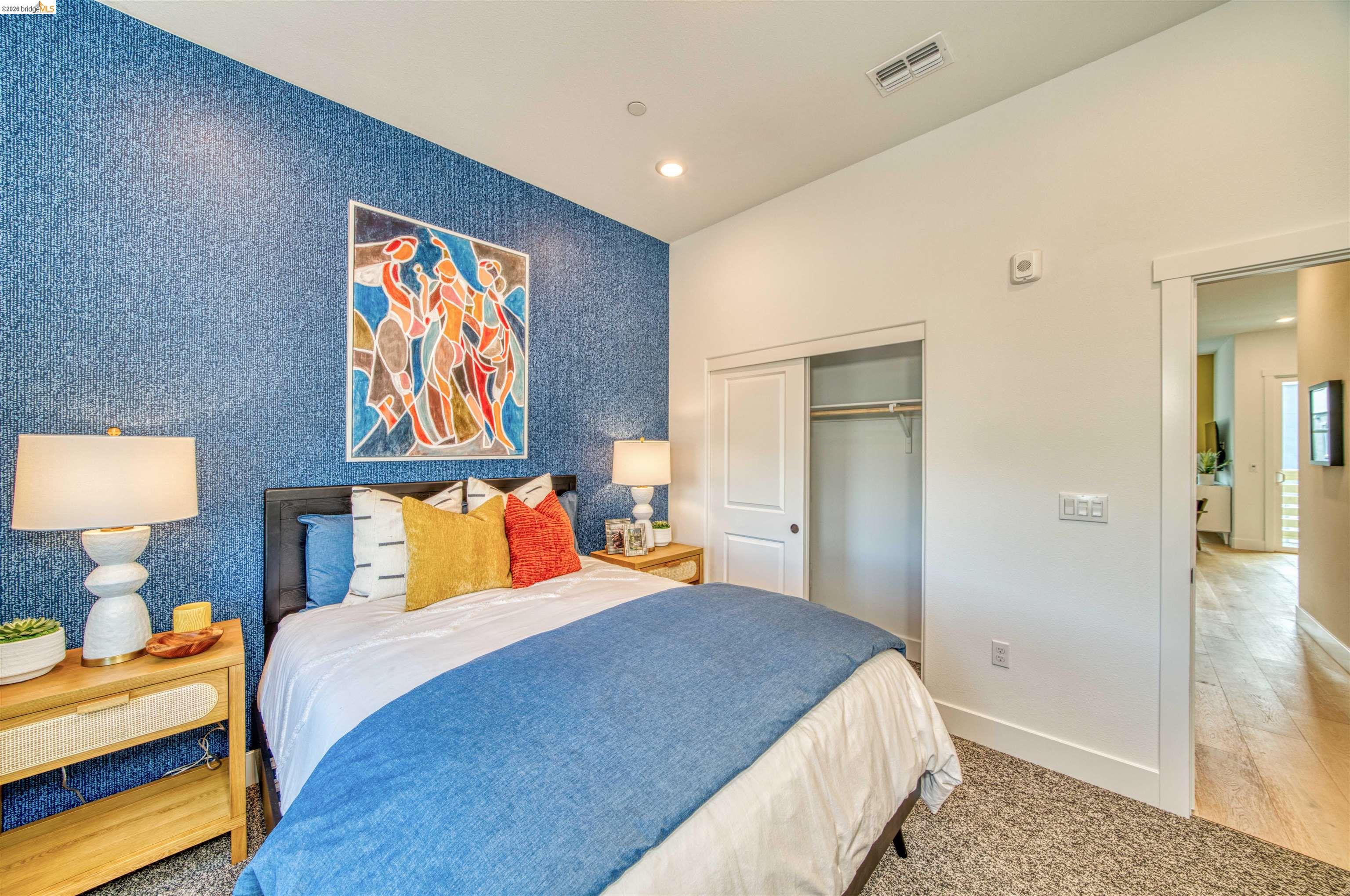 28951 Parkridge Loop, Unit 87 Hayward, CA 94544 - Photo 10 of 23 a bedroom with a bed and a painting on the wall