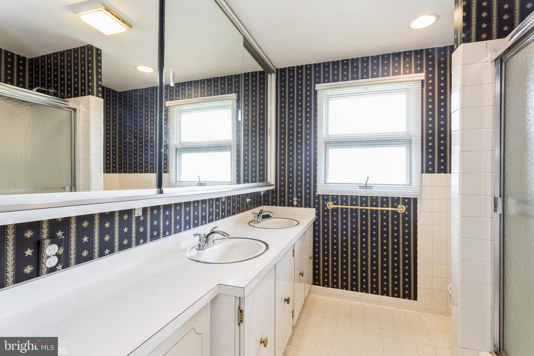 7920 Long Meadow Road Baltimore, MD 21208 - Photo 33 of 40 a bathroom with a sink and a mirror