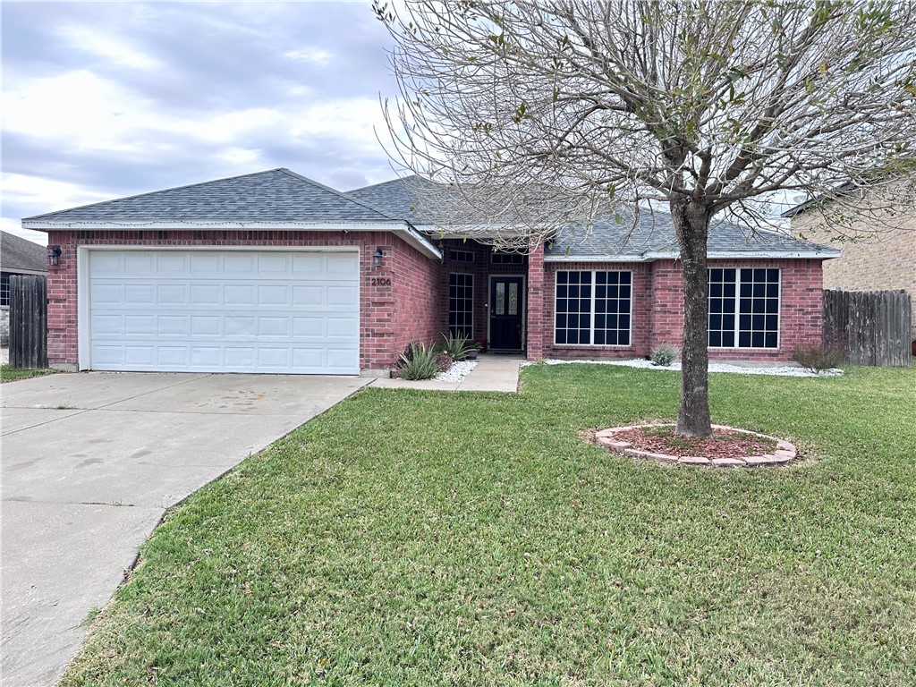 2106 Brook Lane Kingsville, TX 78363 - Photo 1 of 38 a front view of a house with a yard and garage