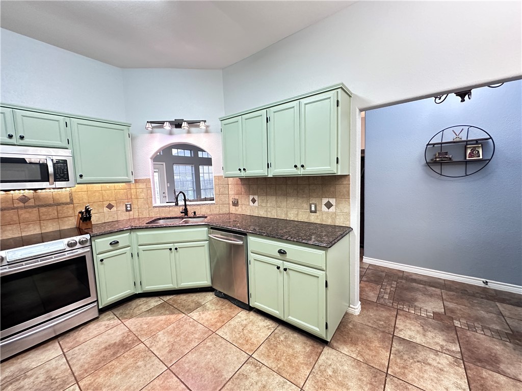 2106 Brook Lane Kingsville, TX 78363 - Photo 12 of 38 a kitchen with stainless steel appliances granite countertop a sink and cabinets