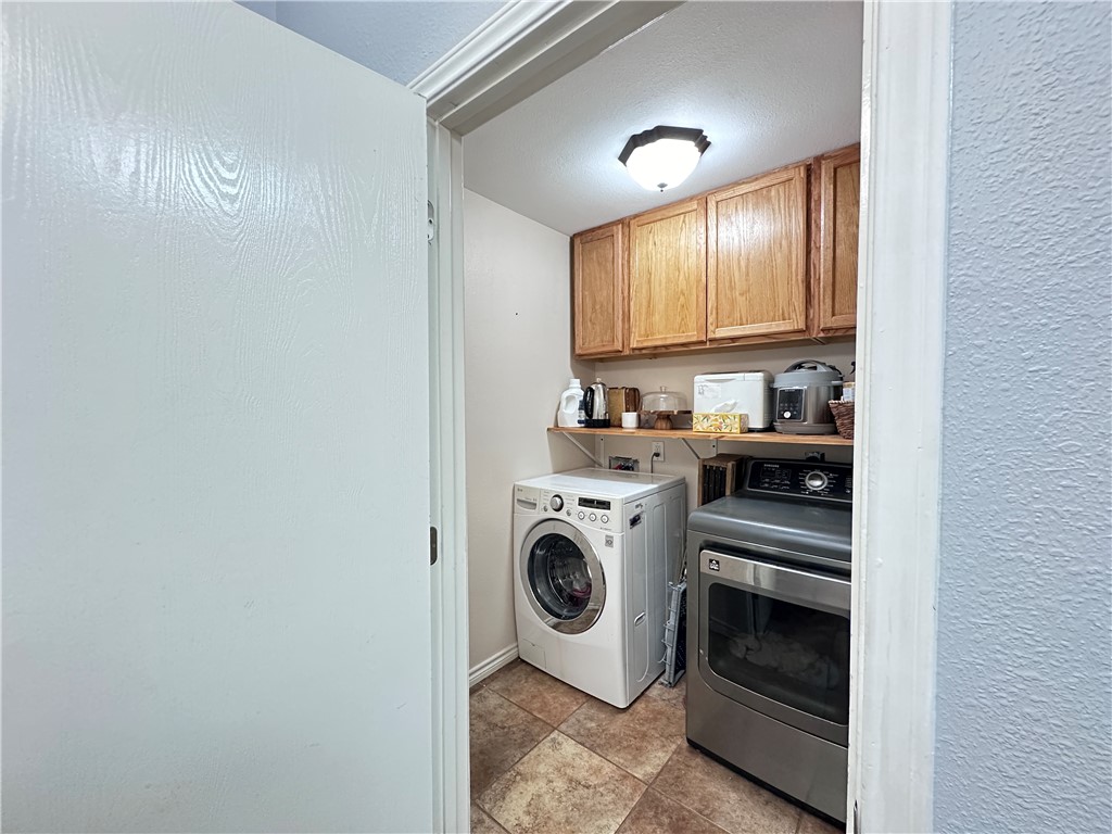 2106 Brook Lane Kingsville, TX 78363 - Photo 14 of 38 a view of a kitchen with a sink and a washer dryer