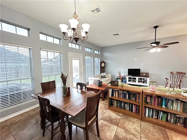 a view of a dining room with furniture and a bookshelf