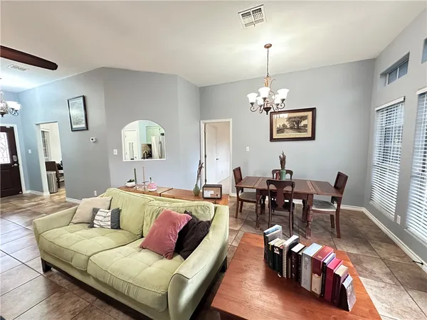 a living room with furniture and a chandelier