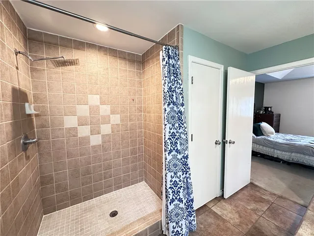 a bathroom with a shower and a sink