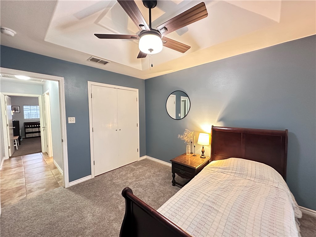 2106 Brook Lane Kingsville, TX 78363 - Photo 31 of 38 a bedroom with a bed and a chandelier