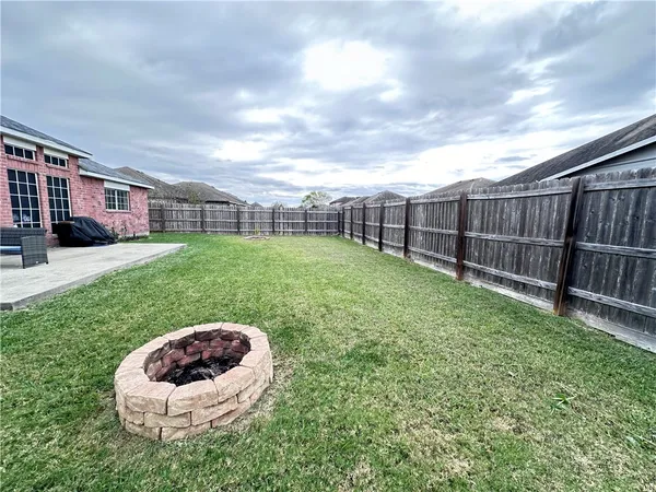 a view of a backyard with a garden and deck