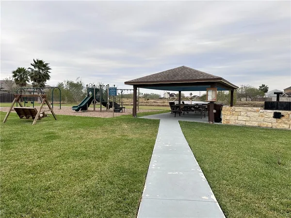 a view of a backyard with sitting area