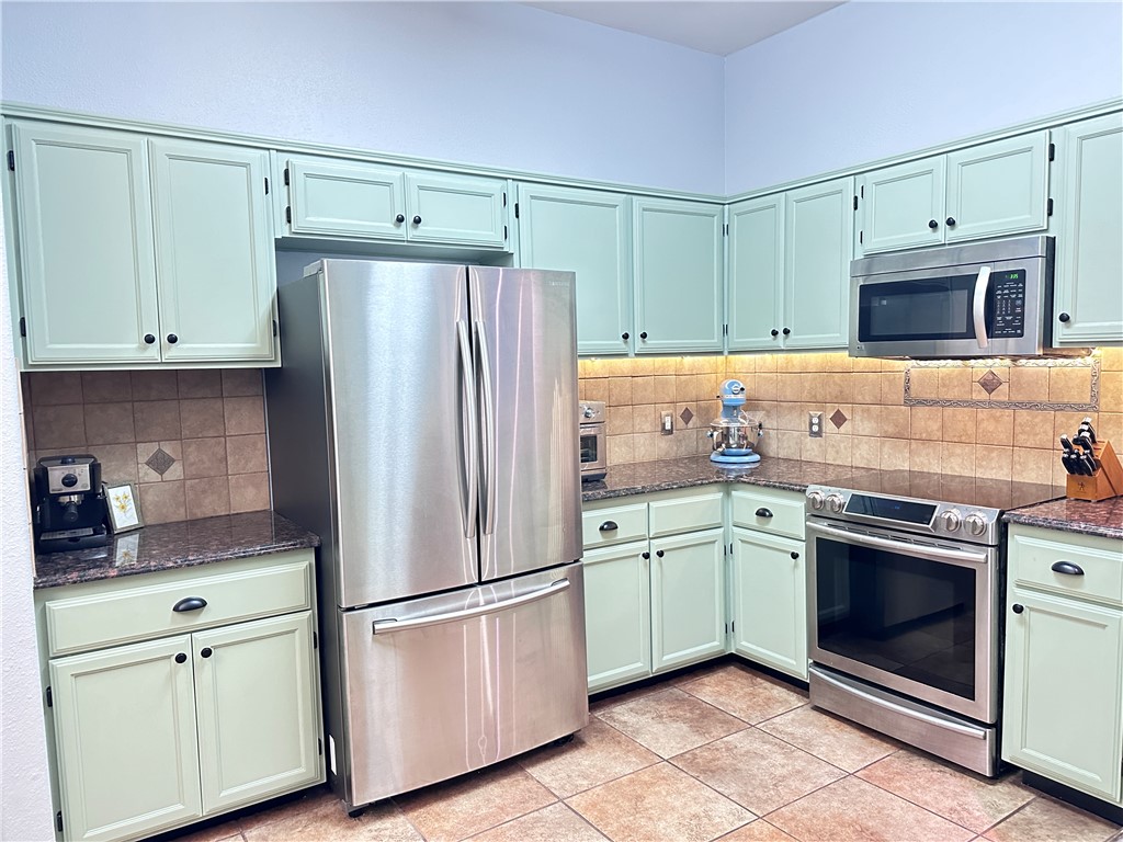 2106 Brook Lane Kingsville, TX 78363 - Photo 9 of 38 a kitchen with cabinets stainless steel appliances and cabinets