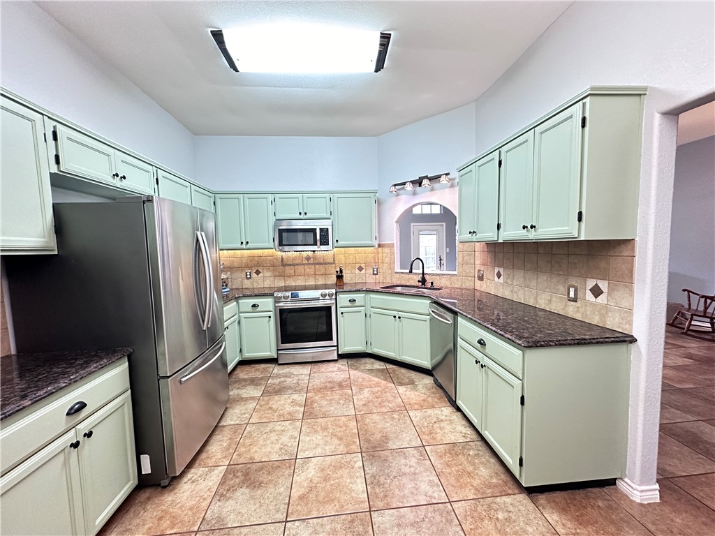 2106 Brook Lane Kingsville, TX 78363 - Photo 10 of 38 a kitchen with a cabinets and steel stainless steel appliances