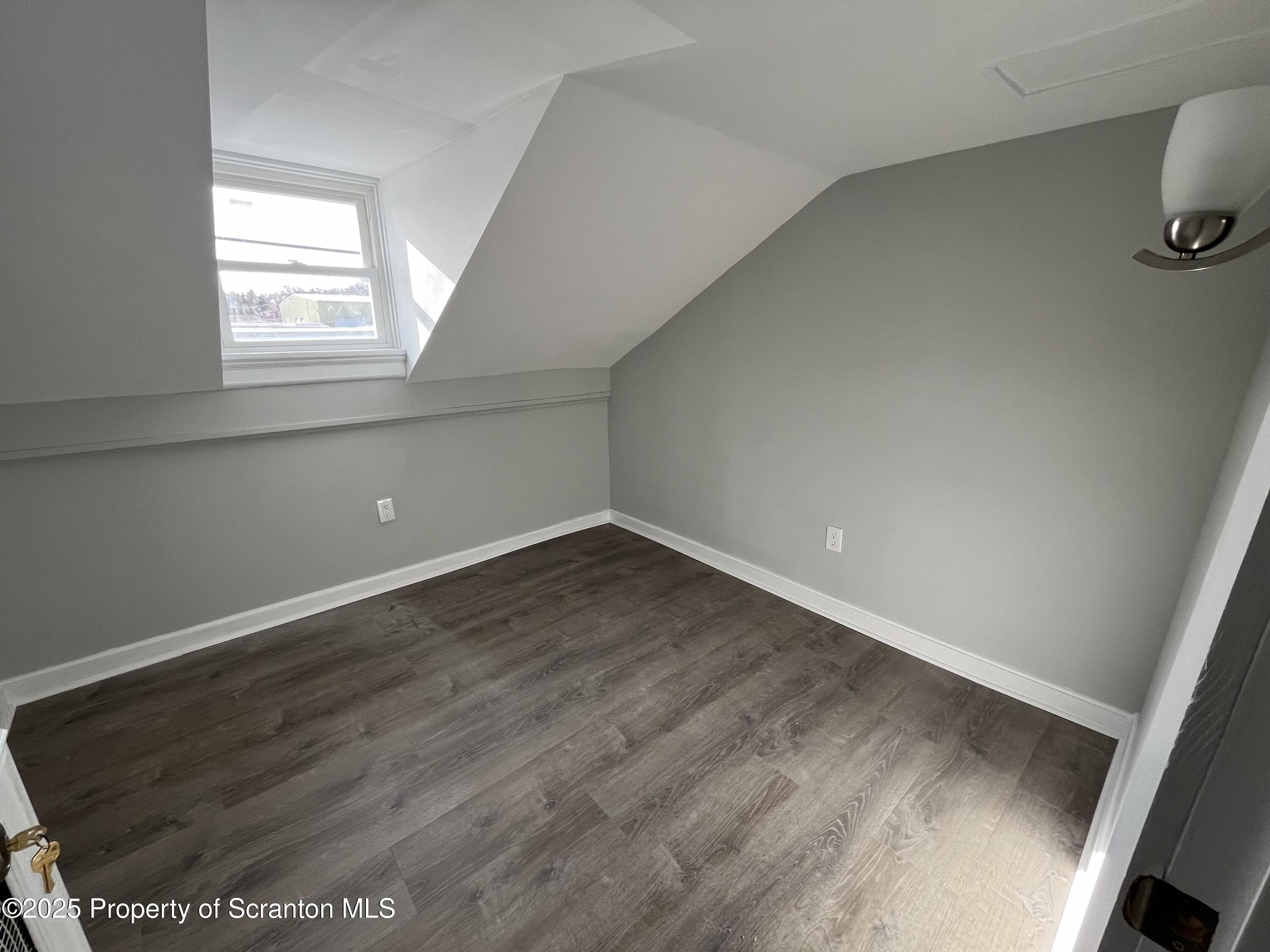 909 Battle Street Scranton, PA 18508 - Photo 11 of 13 an empty room with wooden floor and windows