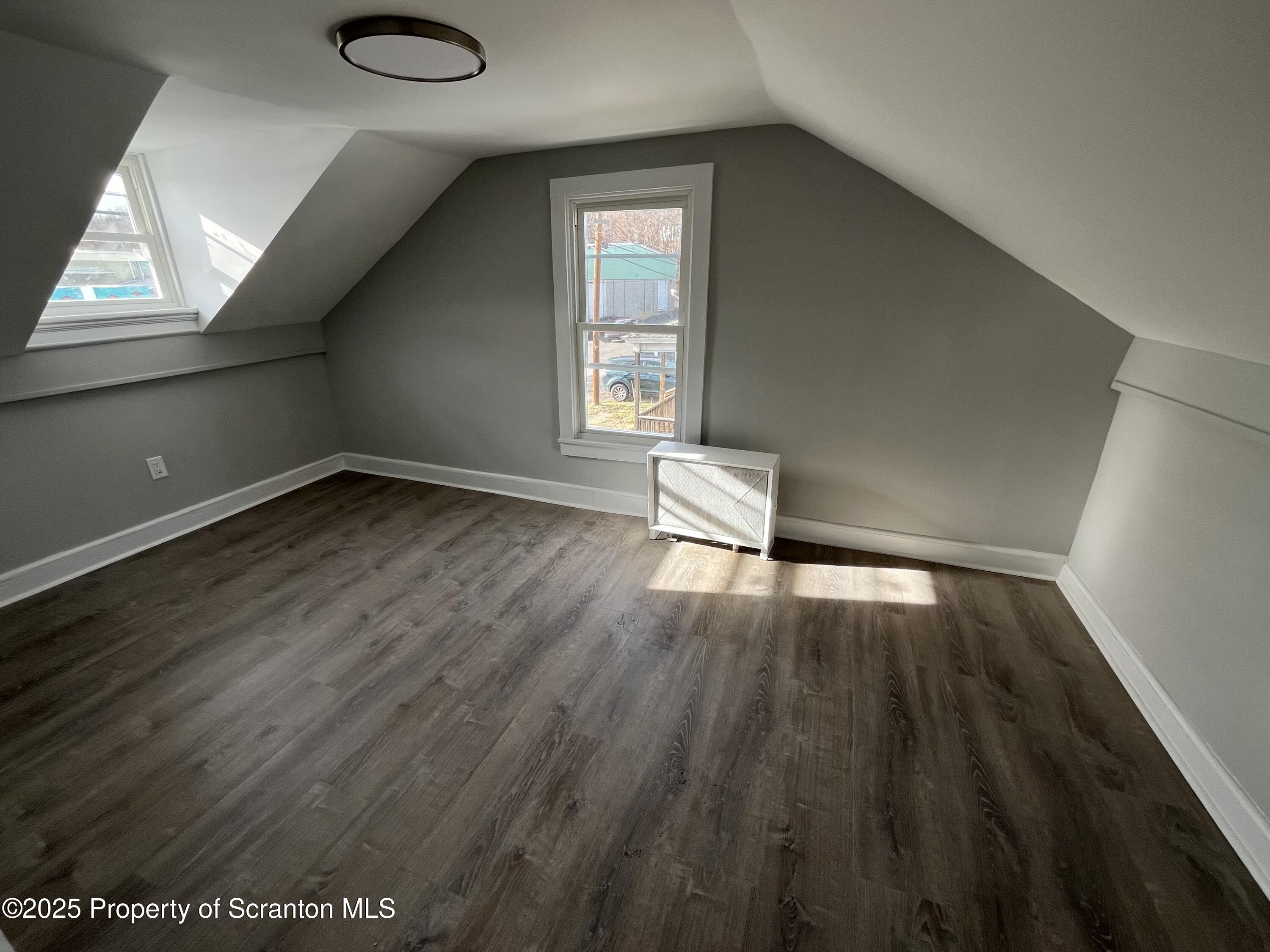 909 Battle Street Scranton, PA 18508 - Photo 12 of 13 a view of empty room with wooden floor and fan