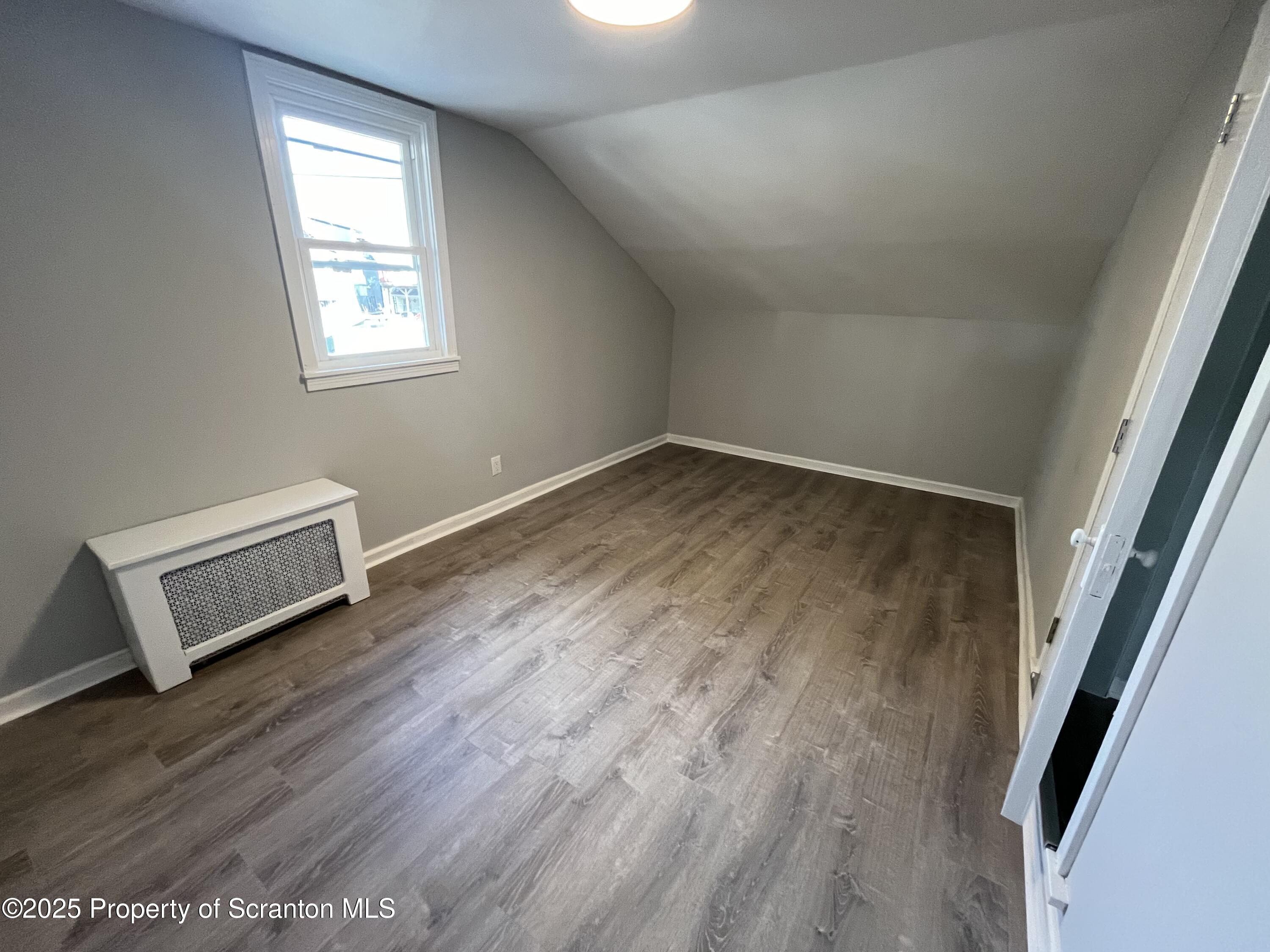 909 Battle Street Scranton, PA 18508 - Photo 13 of 13 a view of a room with wooden floor and window