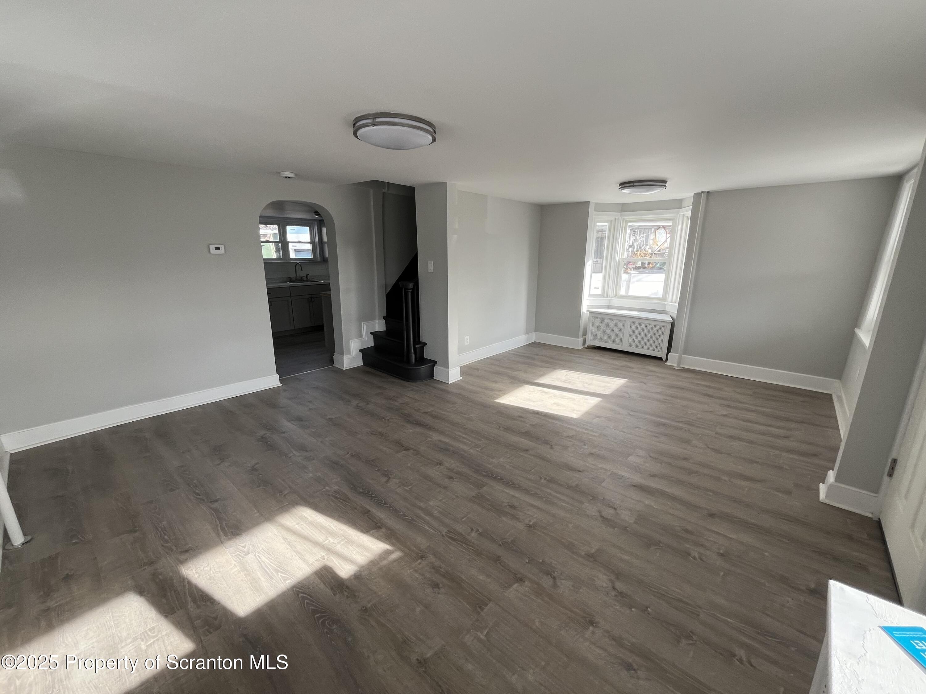 909 Battle Street Scranton, PA 18508 - Photo 2 of 13 a view of empty room with window and fireplace