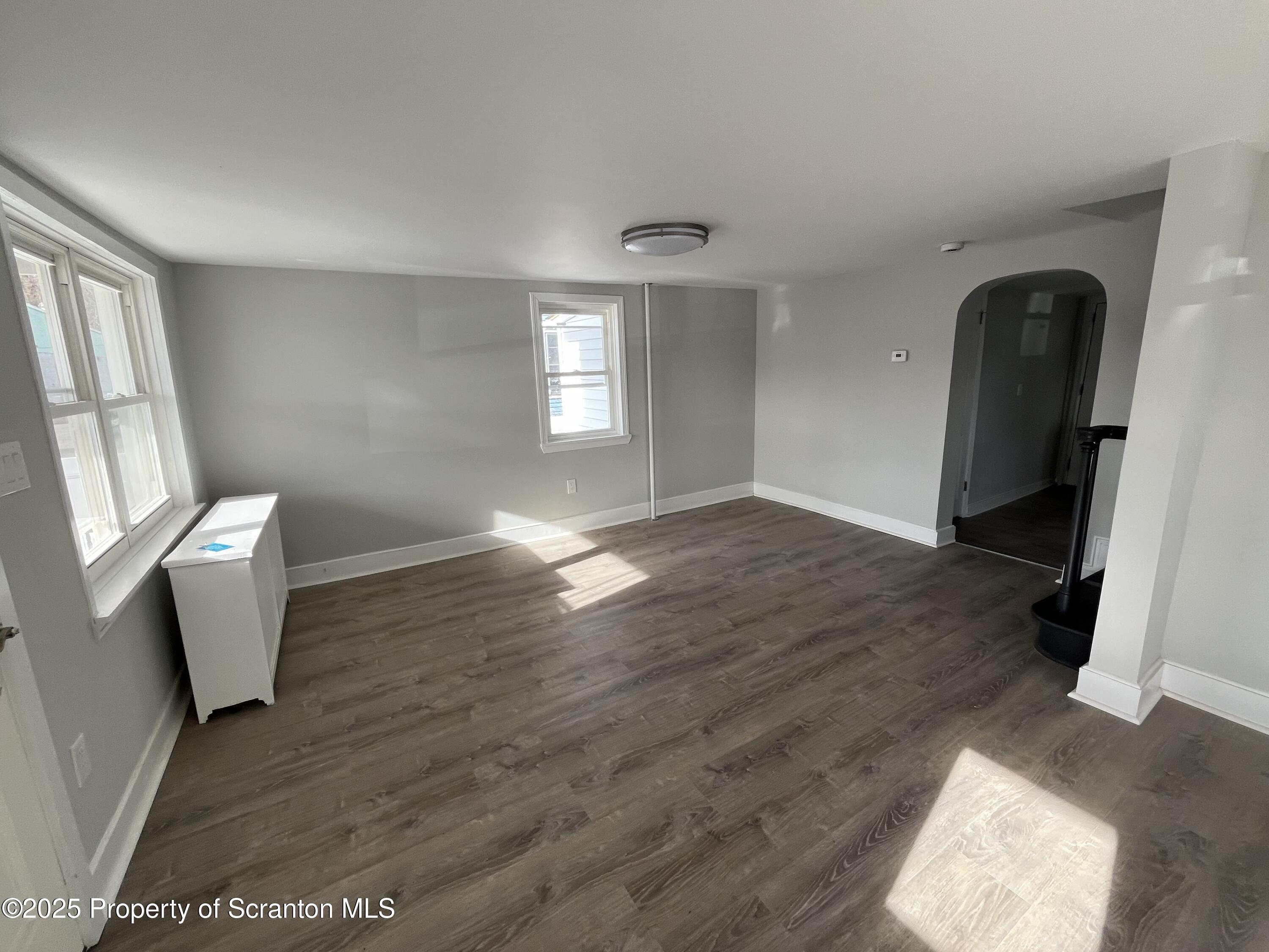 909 Battle Street Scranton, PA 18508 - Photo 4 of 13 a view of empty room with wooden floor and fan