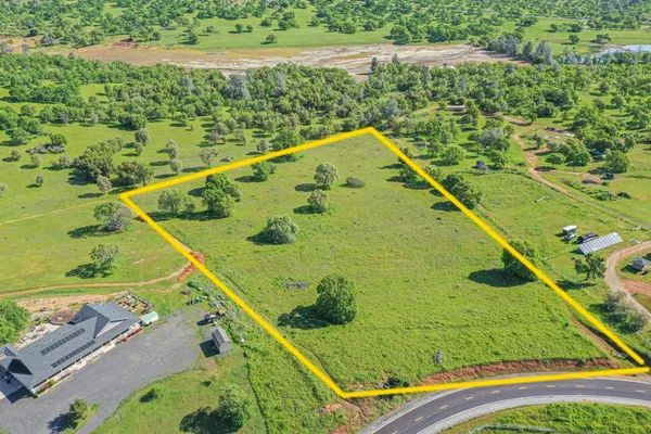 a view of a pool and trees in the background