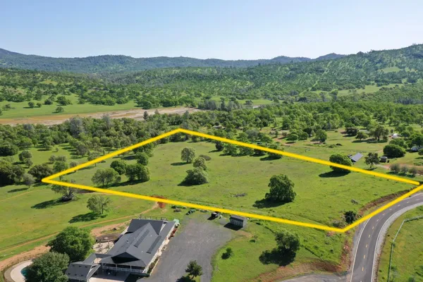 a view of a two chairs in the balcony