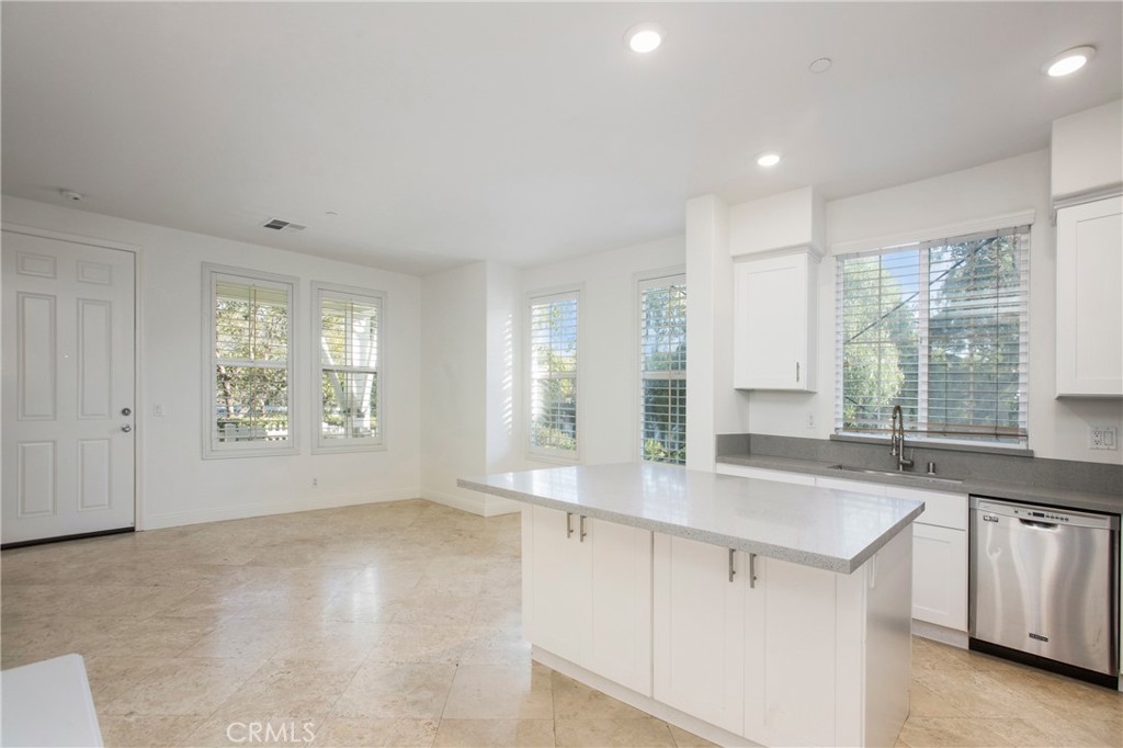 40 Platinum Circle Ladera Ranch, CA 92694 - Photo 6 of 15 a view of a kitchen with a sink and dishwasher with wooden floor