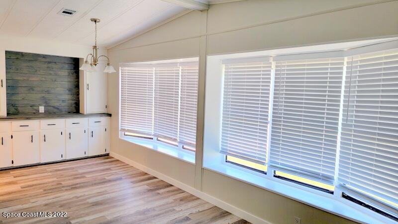 915 Fir Street Sebastian, FL 32976 - Photo 11 of 33 a view of a kitchen with wooden floor and white cabinet