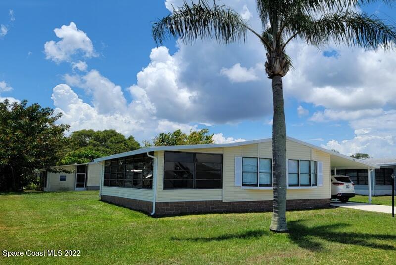 915 Fir Street Sebastian, FL 32976 - Photo 3 of 33 a front view of a house with garden and trees