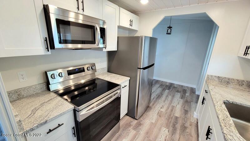 915 Fir Street Sebastian, FL 32976 - Photo 4 of 33 a kitchen with a stove and a microwave