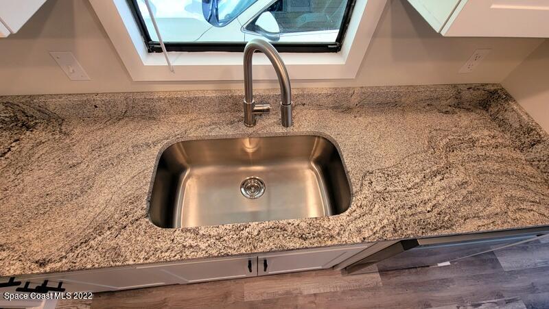 915 Fir Street Sebastian, FL 32976 - Photo 6 of 33 a bathroom with a granite countertop sink and a window