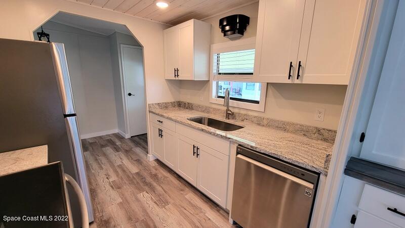 915 Fir Street Sebastian, FL 32976 - Photo 7 of 33 a kitchen with a sink and a refrigerator