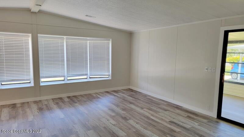 915 Fir Street Sebastian, FL 32976 - Photo 10 of 33 a view of an empty room with wooden floor and a window