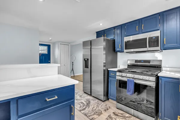 a kitchen with stainless steel appliances granite countertop a refrigerator stove and sink