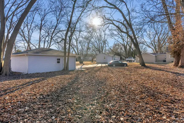 a view of a yard with wooden fence