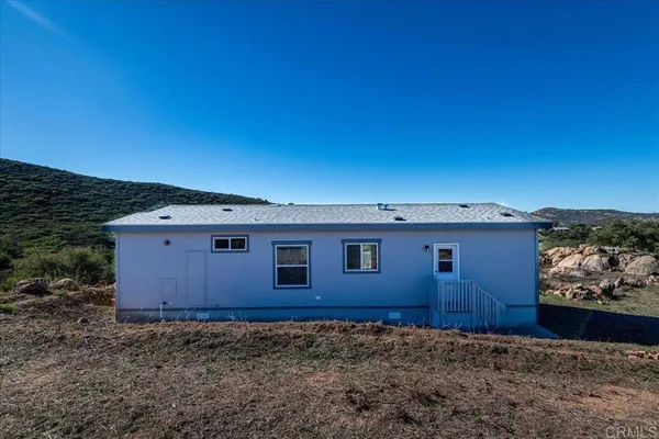 a view of a house with a backyard