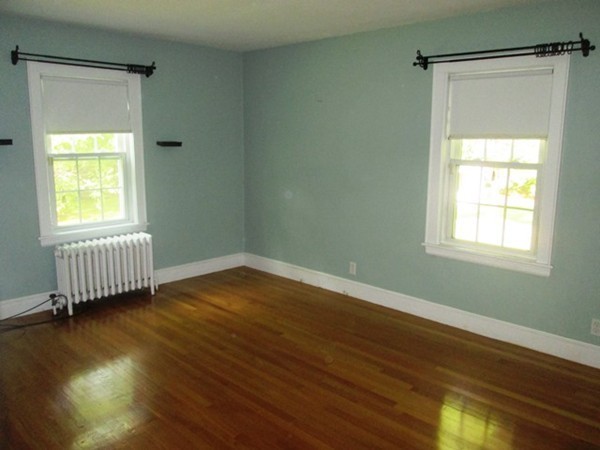 9 Alden Road Needham, MA 02492 - Photo 8 of 16 a view of an empty room with wooden floor and a window
