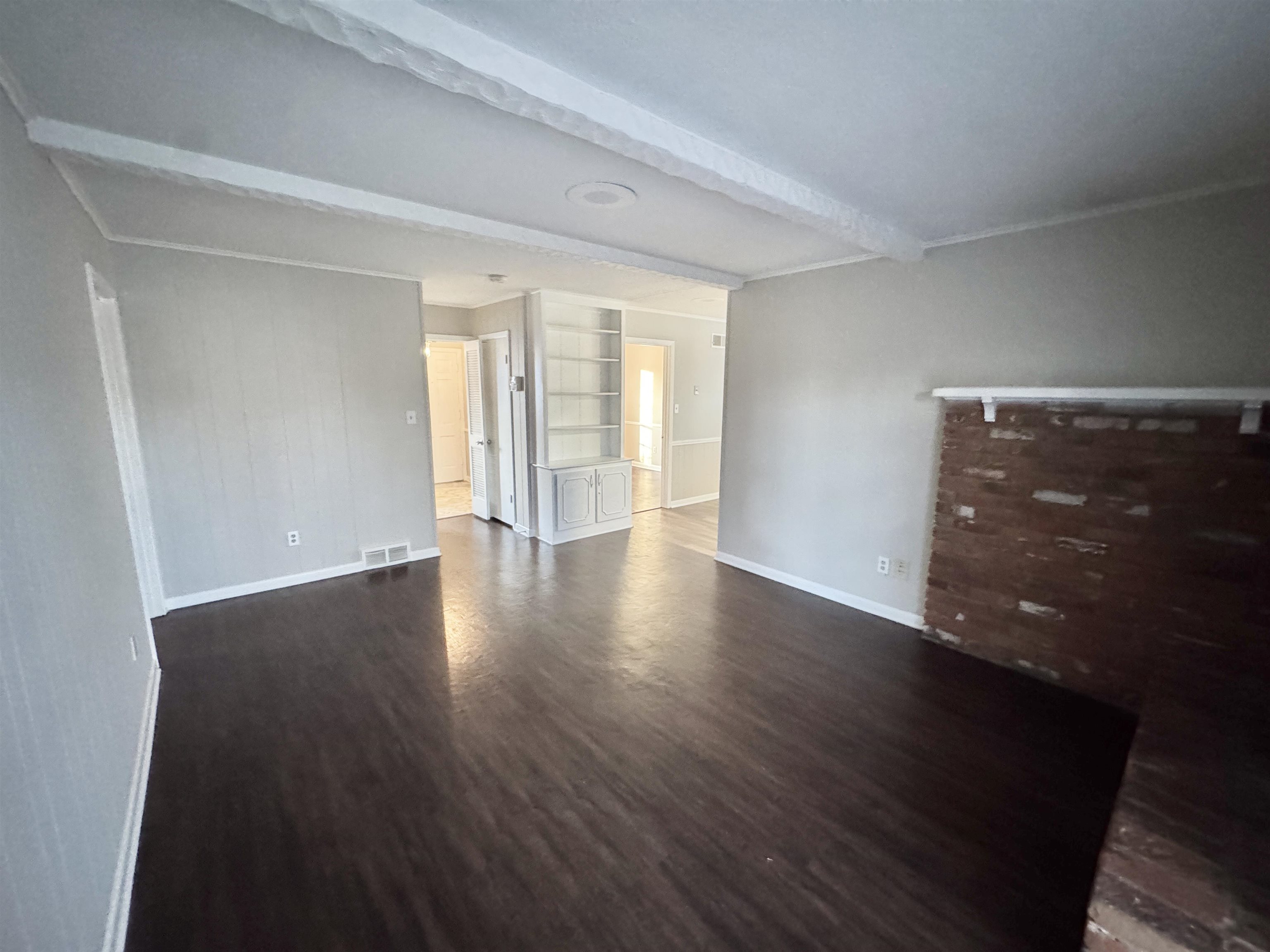 3174 Emerald Street Memphis, TN 38115 - Photo 11 of 28 a view of an empty room with wooden floor and a window