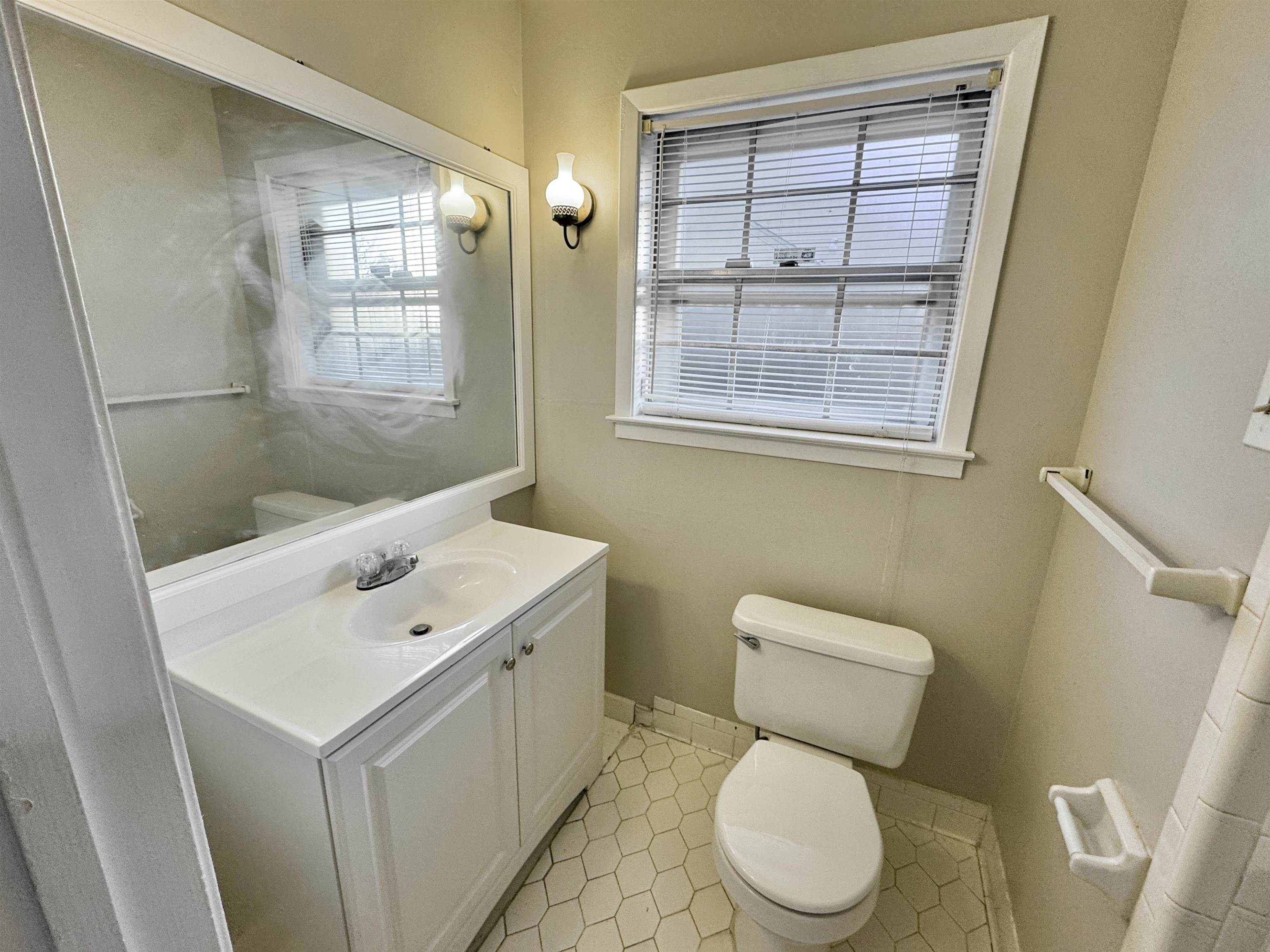 3174 Emerald Street Memphis, TN 38115 - Photo 15 of 28 a white toilet sitting next to a bathroom sink