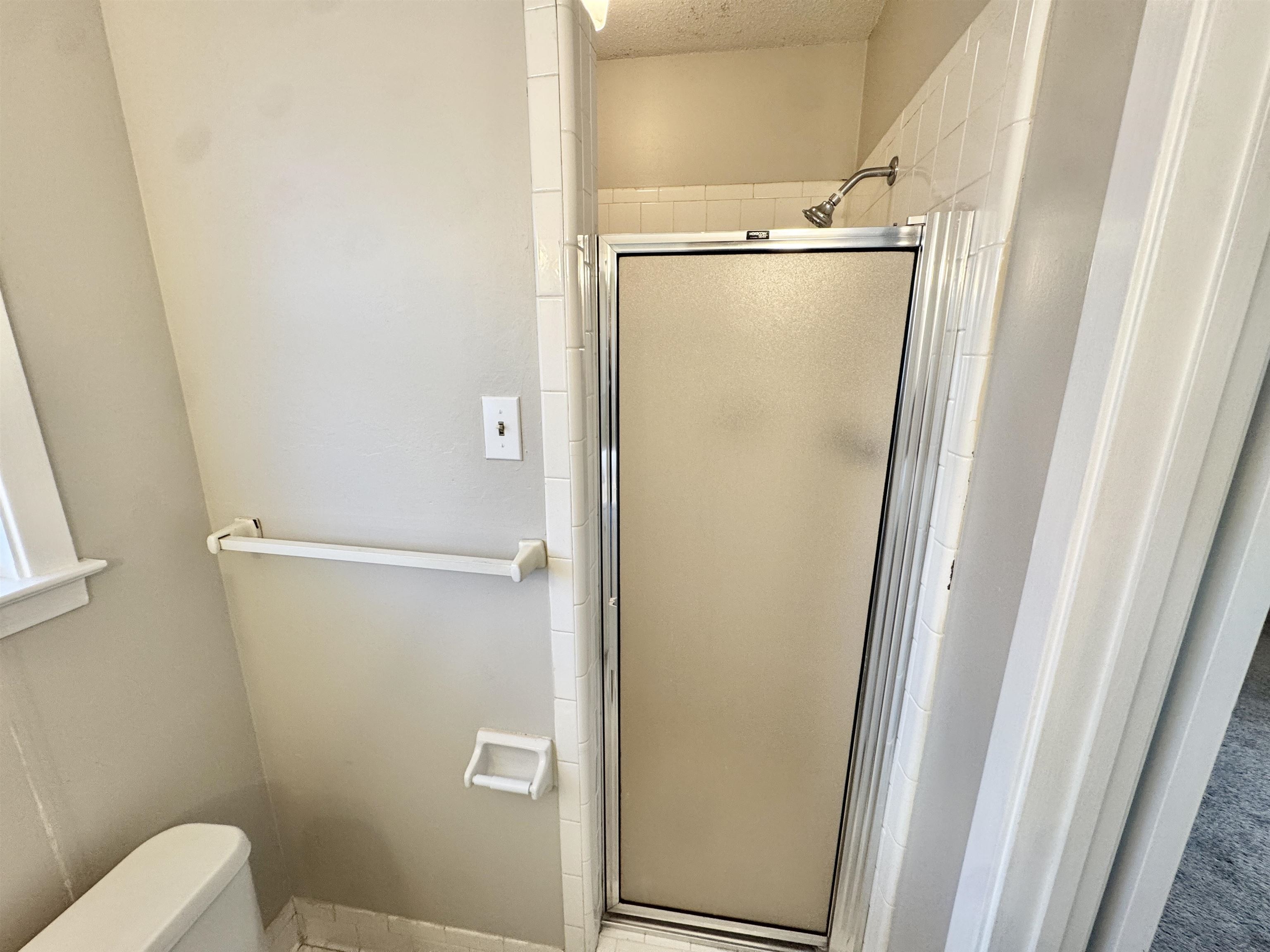 3174 Emerald Street Memphis, TN 38115 - Photo 16 of 28 a bathroom with a glass shower door