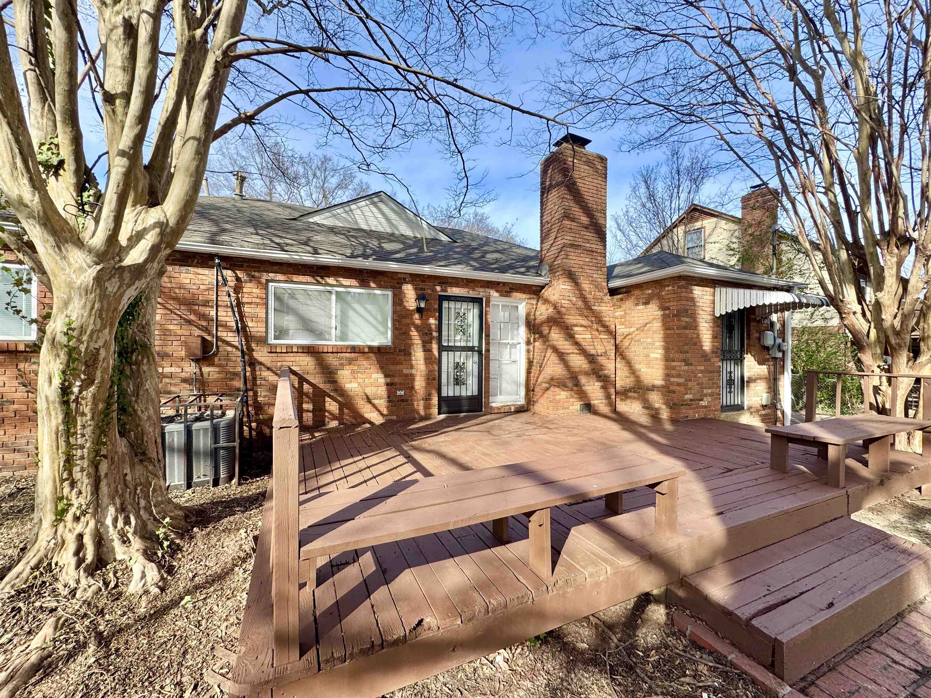 3174 Emerald Street Memphis, TN 38115 - Photo 27 of 28 a backyard of a house with barbeque oven table and chairs