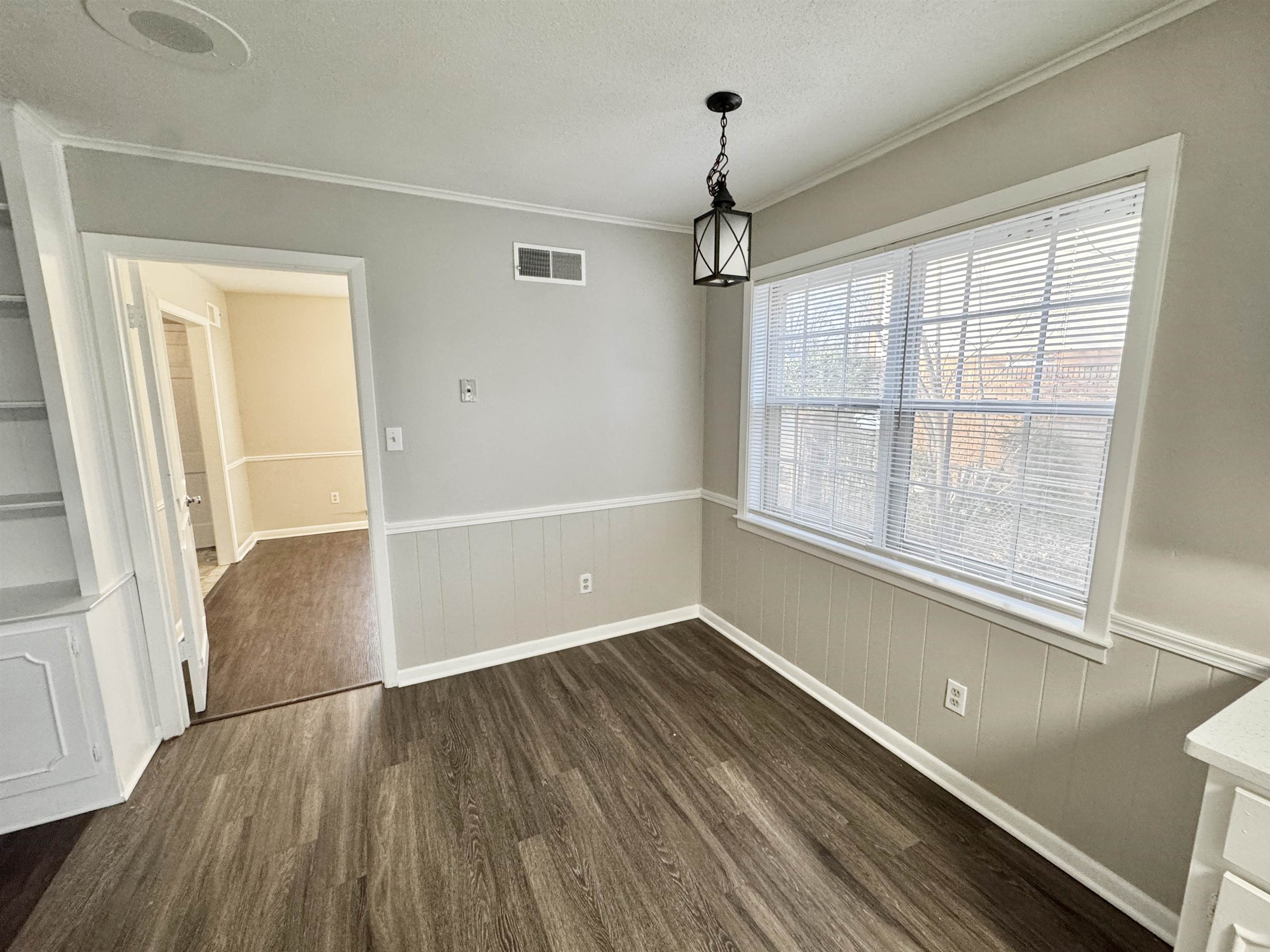 3174 Emerald Street Memphis, TN 38115 - Photo 6 of 28 a view of an empty room with a window and wooden floor