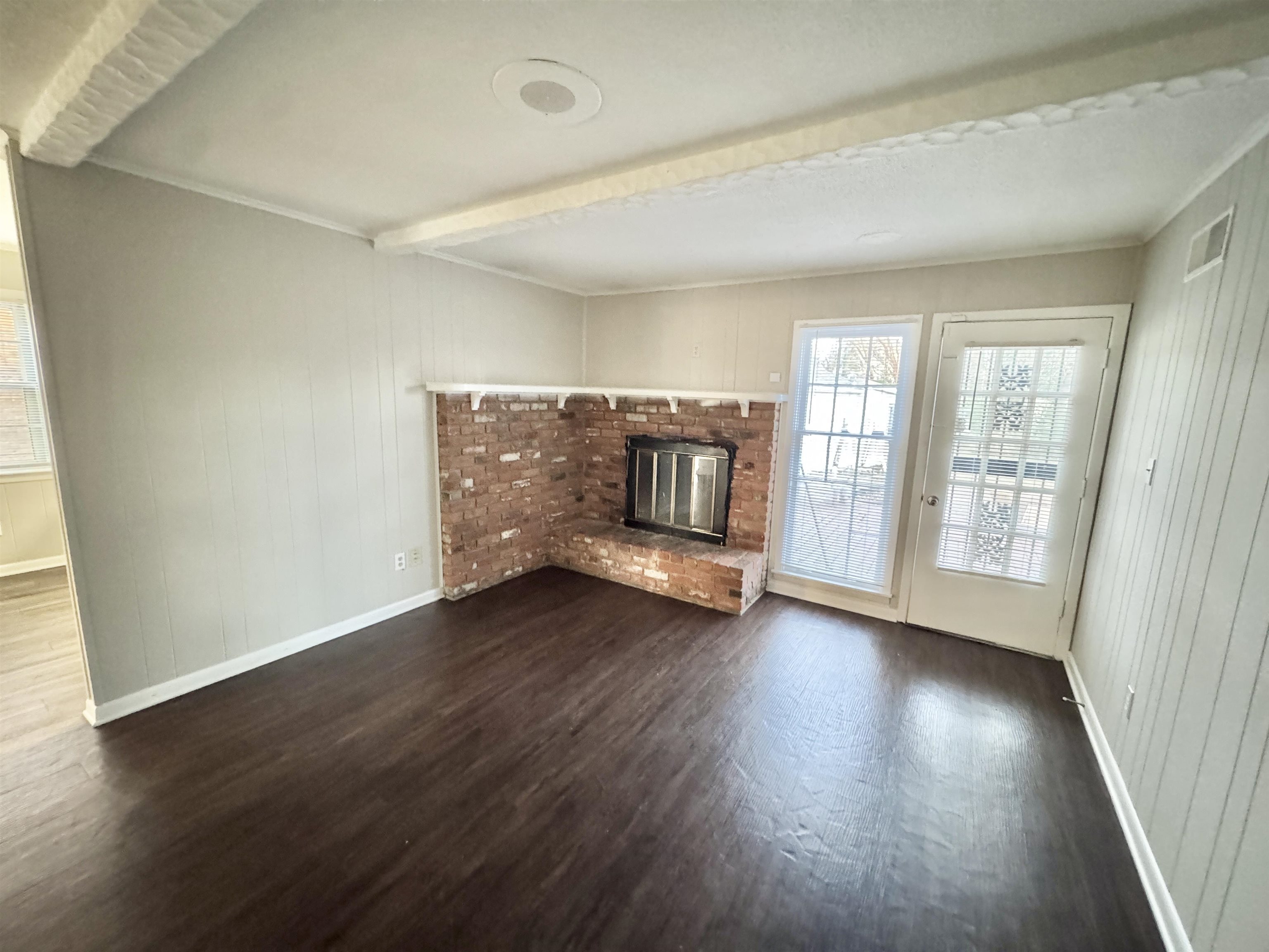 3174 Emerald Street Memphis, TN 38115 - Photo 7 of 28 an empty room with wooden floor and windows