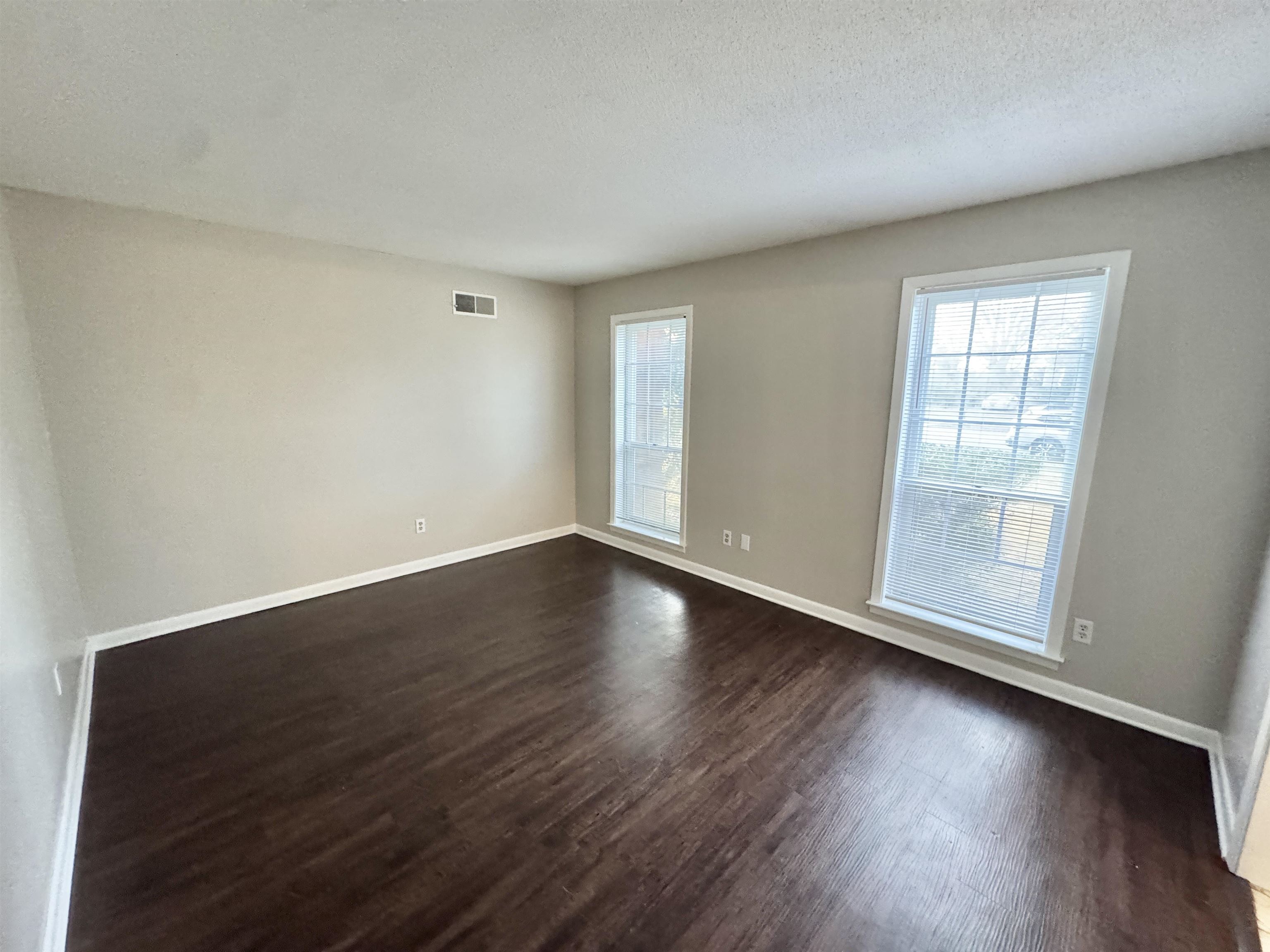 3174 Emerald Street Memphis, TN 38115 - Photo 8 of 28 an empty room with wooden floor and windows