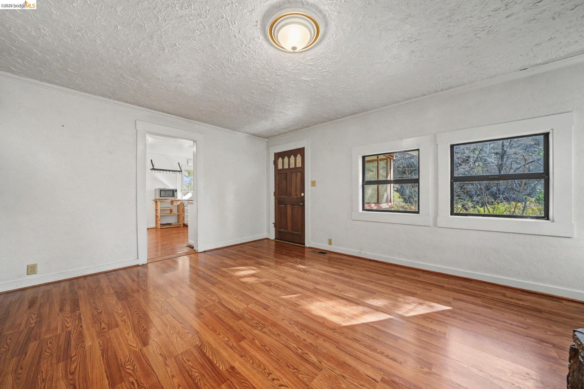 731 Dam Road Murphys, CA 95247 - Photo 19 of 60 wooden floor in an empty room with a window