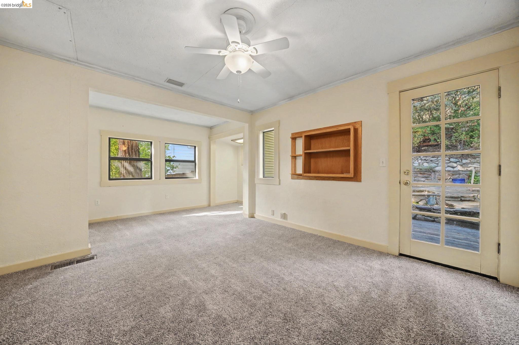 731 Dam Road Murphys, CA 95247 - Photo 23 of 60 an empty room with windows and ceiling fan